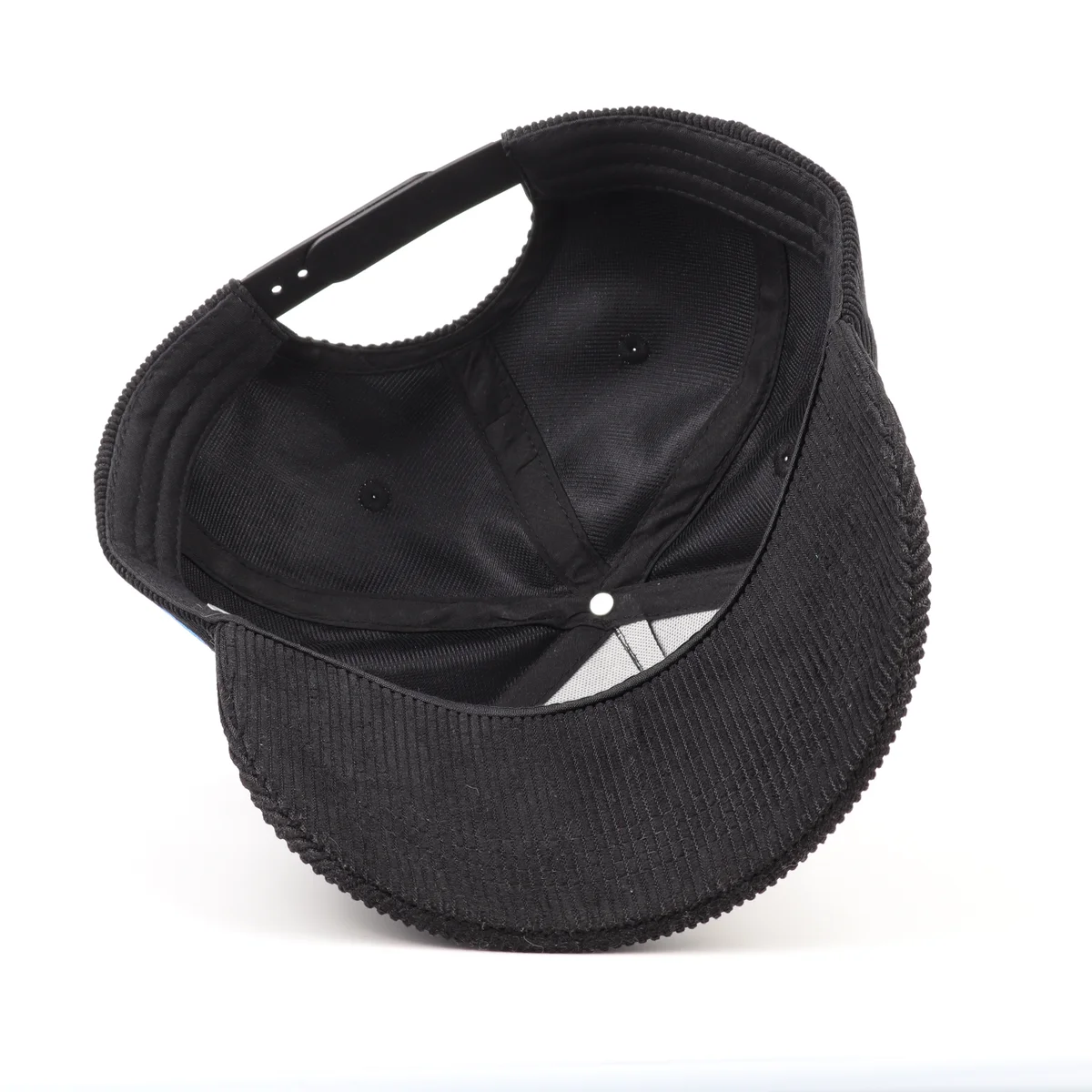 Inside view showing seams, visor stitching and adjustment of black corduroy cap
